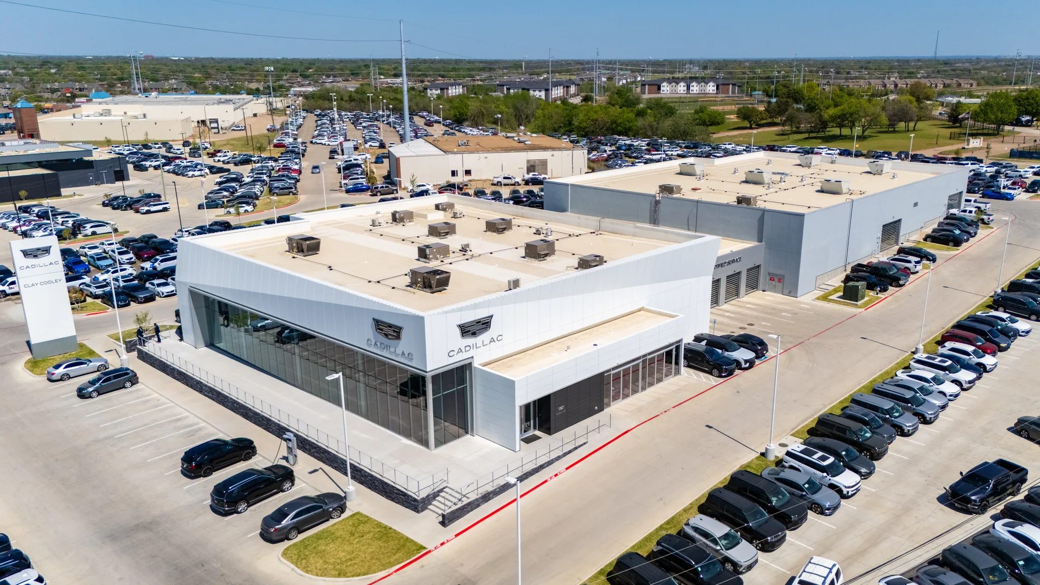 Aerial view of Clay Cooley Cadillac in Mesquite, Texas, showing the showroom, service building and pylon sign, built by The Charles Morgan Group