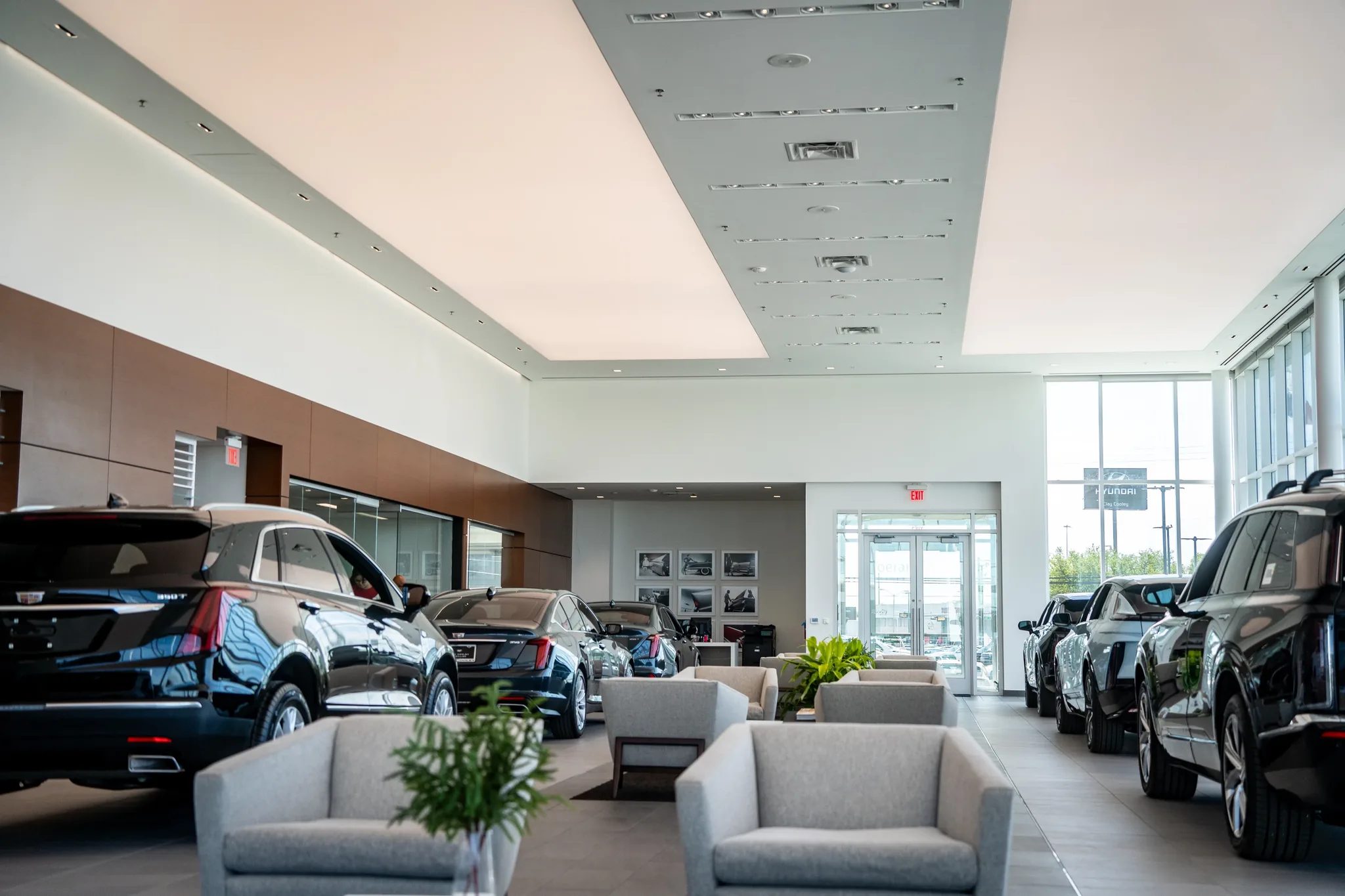Customer lounge inside the showroom at Clay Cooley Cadillac in Mesquite, Texas, surrounded by new Cadillacs, built by The Charles Morgan Group