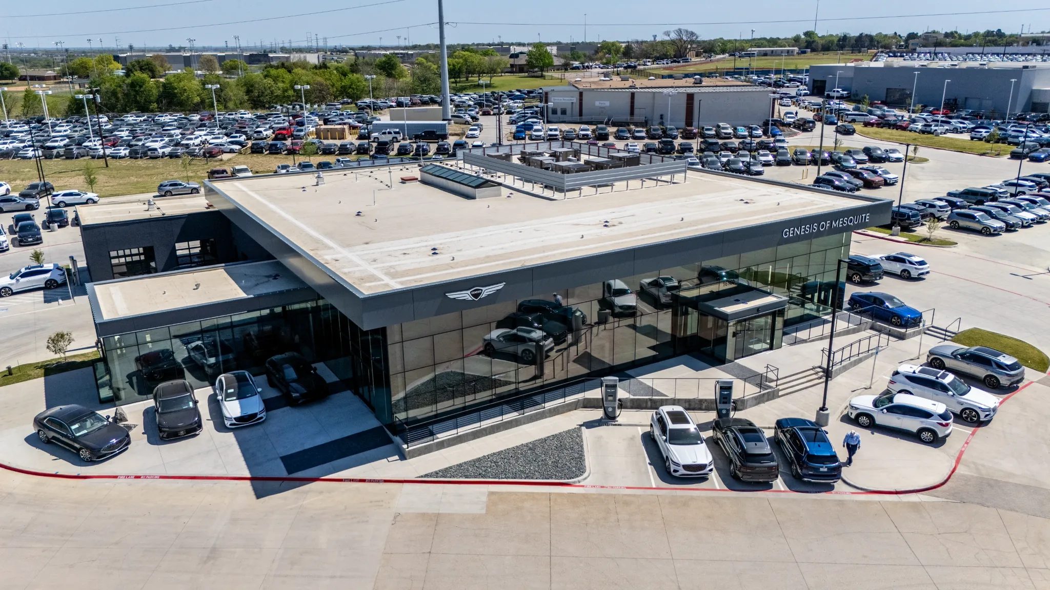 High aerial view of Clay Cooley Genesis of Mesquite in Mesquite, Texas, with its glass showroom and inventory lots, built by The Charles Morgan Group