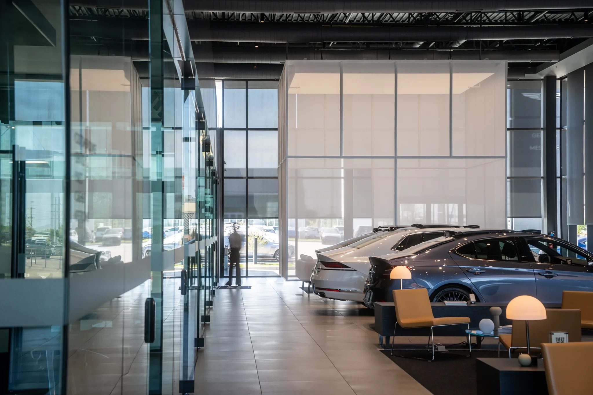 Showroom interior at Clay Cooley Genesis of Mesquite in Mesquite, Texas, with Genesis sedans and lounge seating, built by The Charles Morgan Group