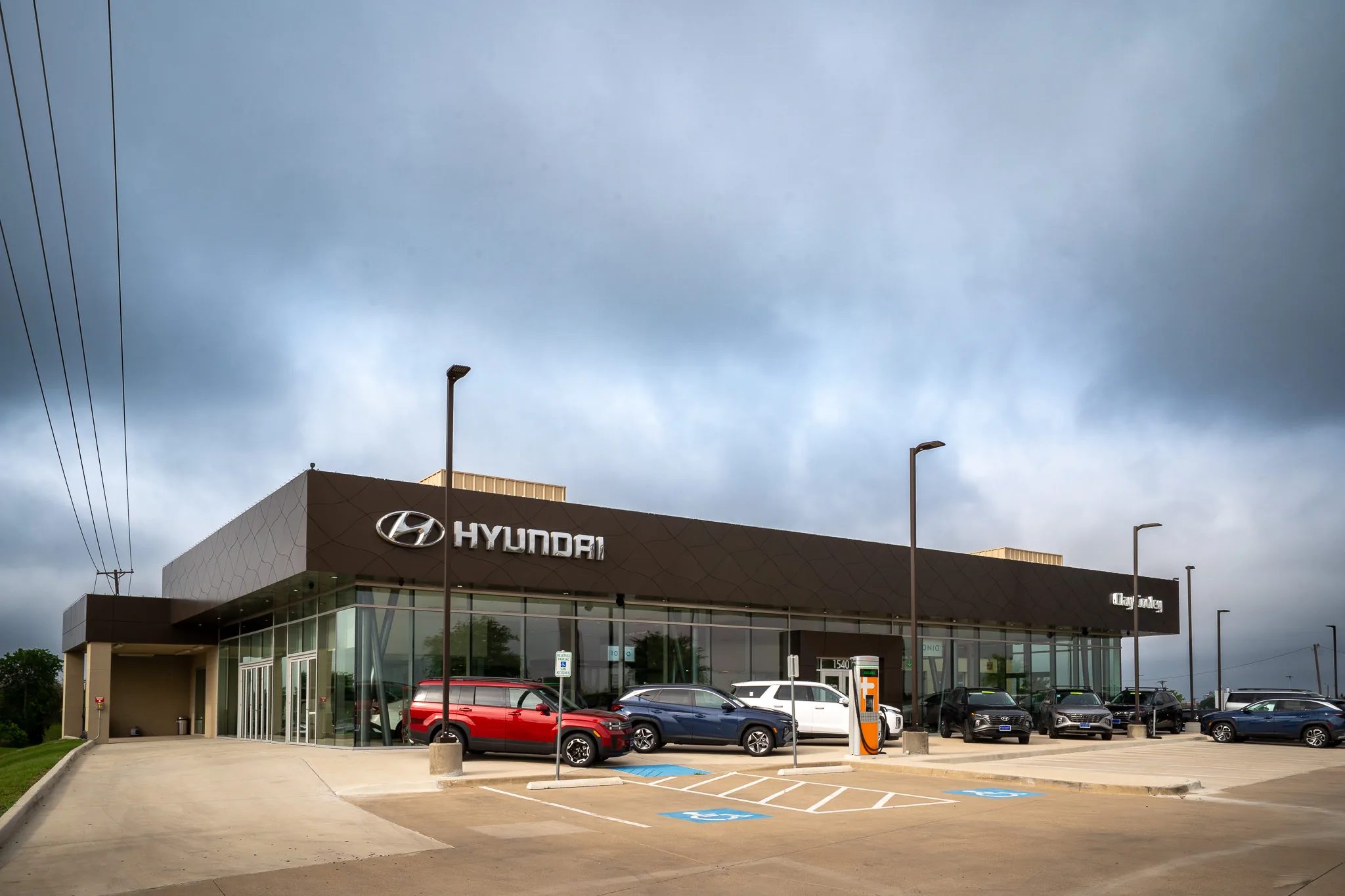 Angled exterior of Clay Cooley Hyundai of Rockwall in Rockwall, Texas, with Hyundai signage and new SUVs out front, built by The Charles Morgan Group