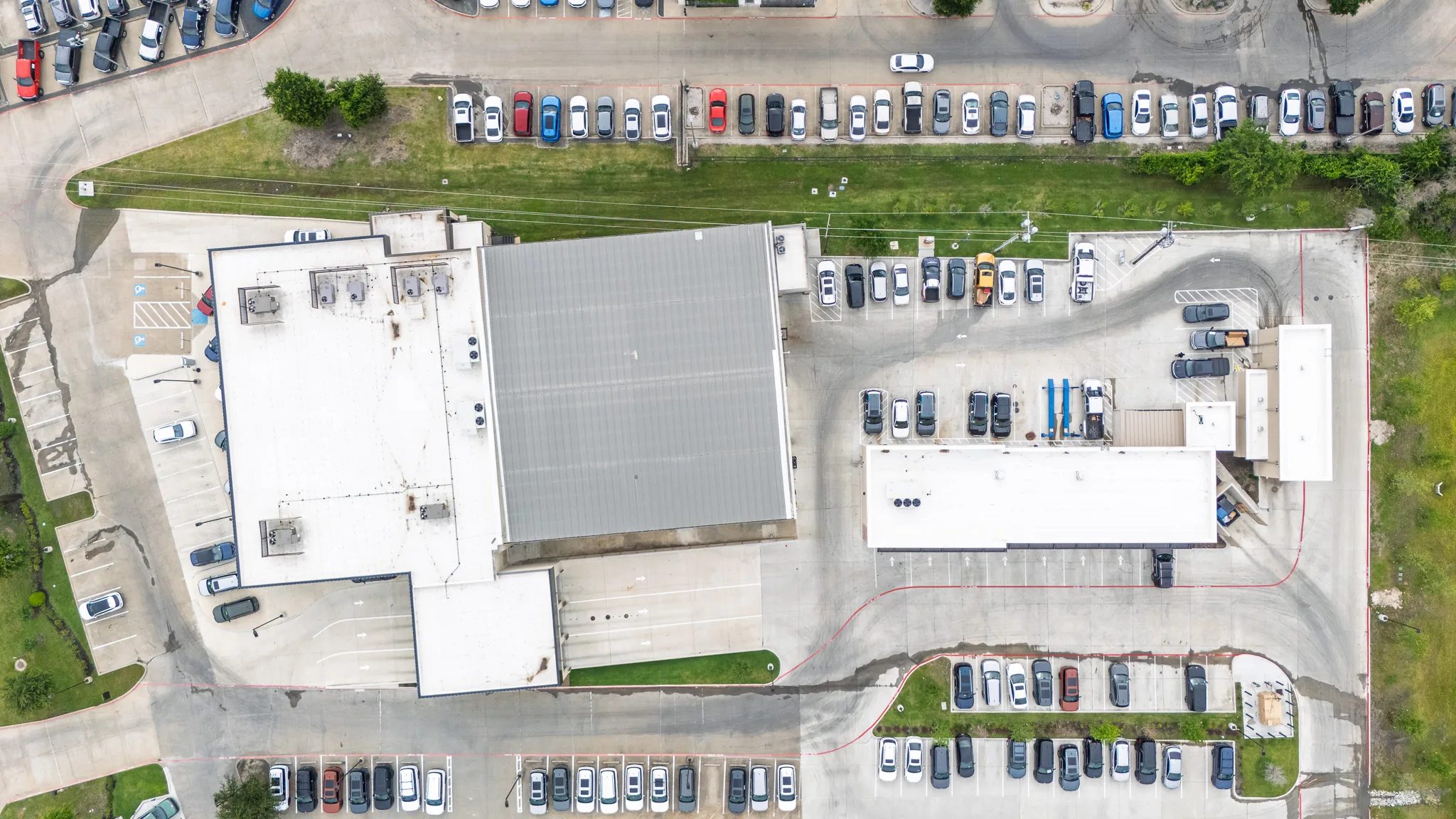 Top-down aerial of Clay Cooley Hyundai of Rockwall in Rockwall, Texas, with its roofs and inventory rows, built by The Charles Morgan Group