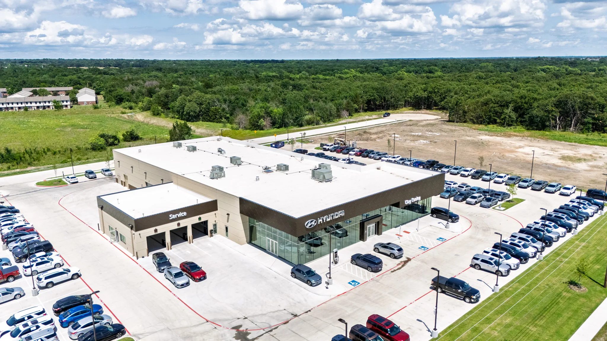 Aerial view of Clay Cooley Hyundai of Terrell in Terrell, Texas, with its showroom, service wing and inventory lots, built by The Charles Morgan Group