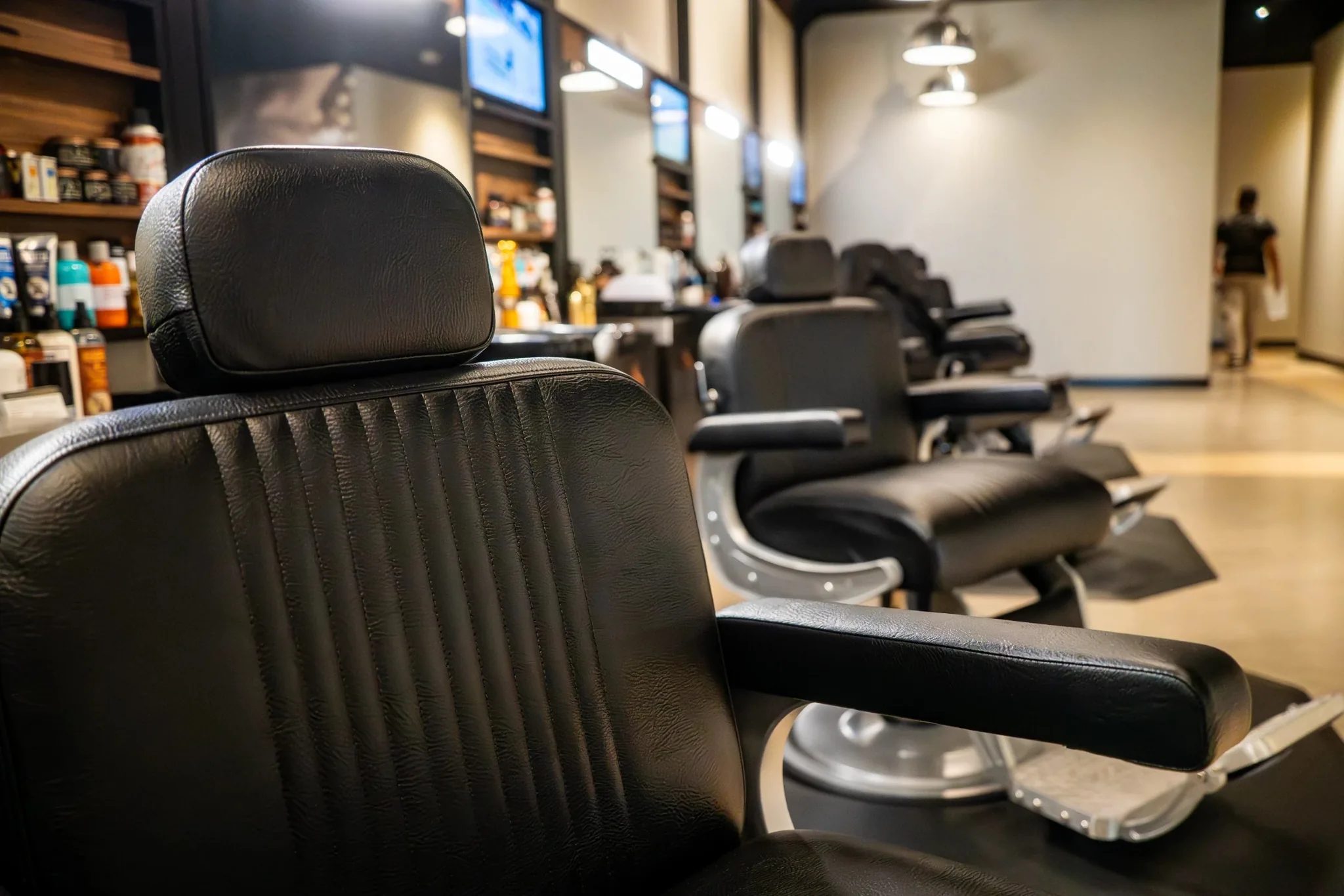 Close-up of a black leather barber chair at Hammer & Nails Grooming Shop for Guys in Mansfield, Texas, built by The Charles Morgan Group
