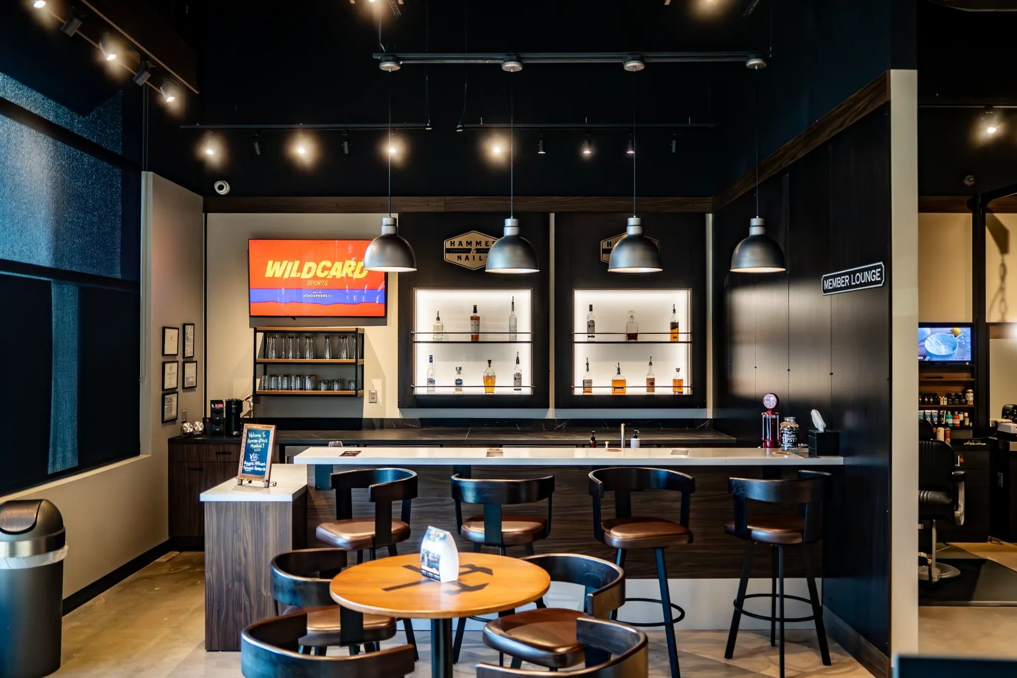 Member lounge bar at Hammer & Nails Grooming Shop for Guys in Mansfield, Texas, seen straight on, built by The Charles Morgan Group