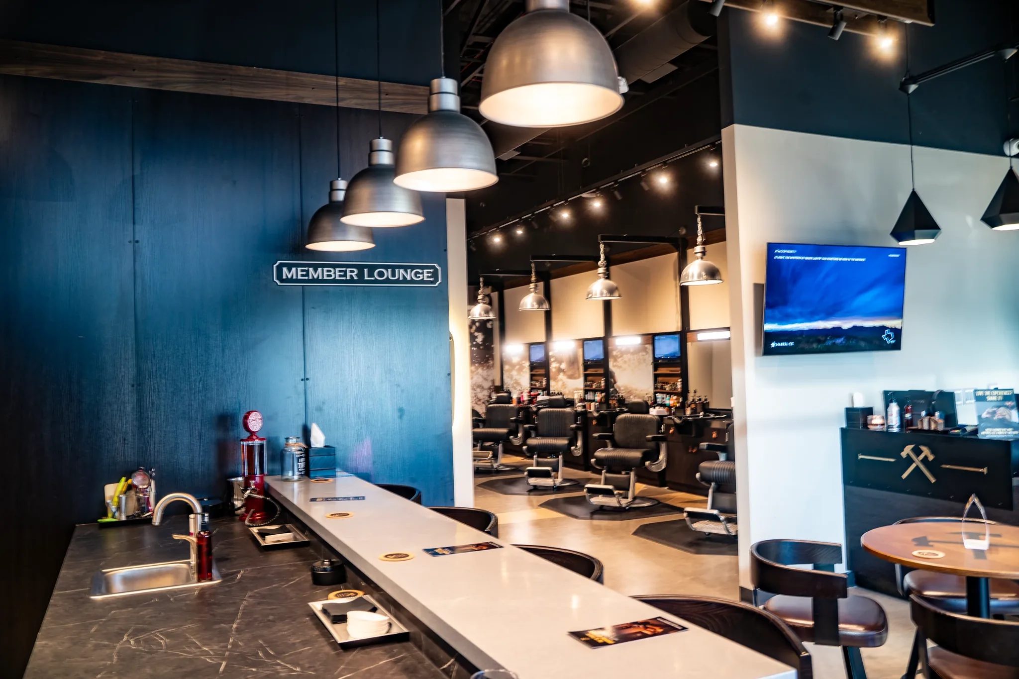 Member Lounge bar counter looking toward the barber floor at Hammer & Nails in Mansfield, Texas, built by The Charles Morgan Group