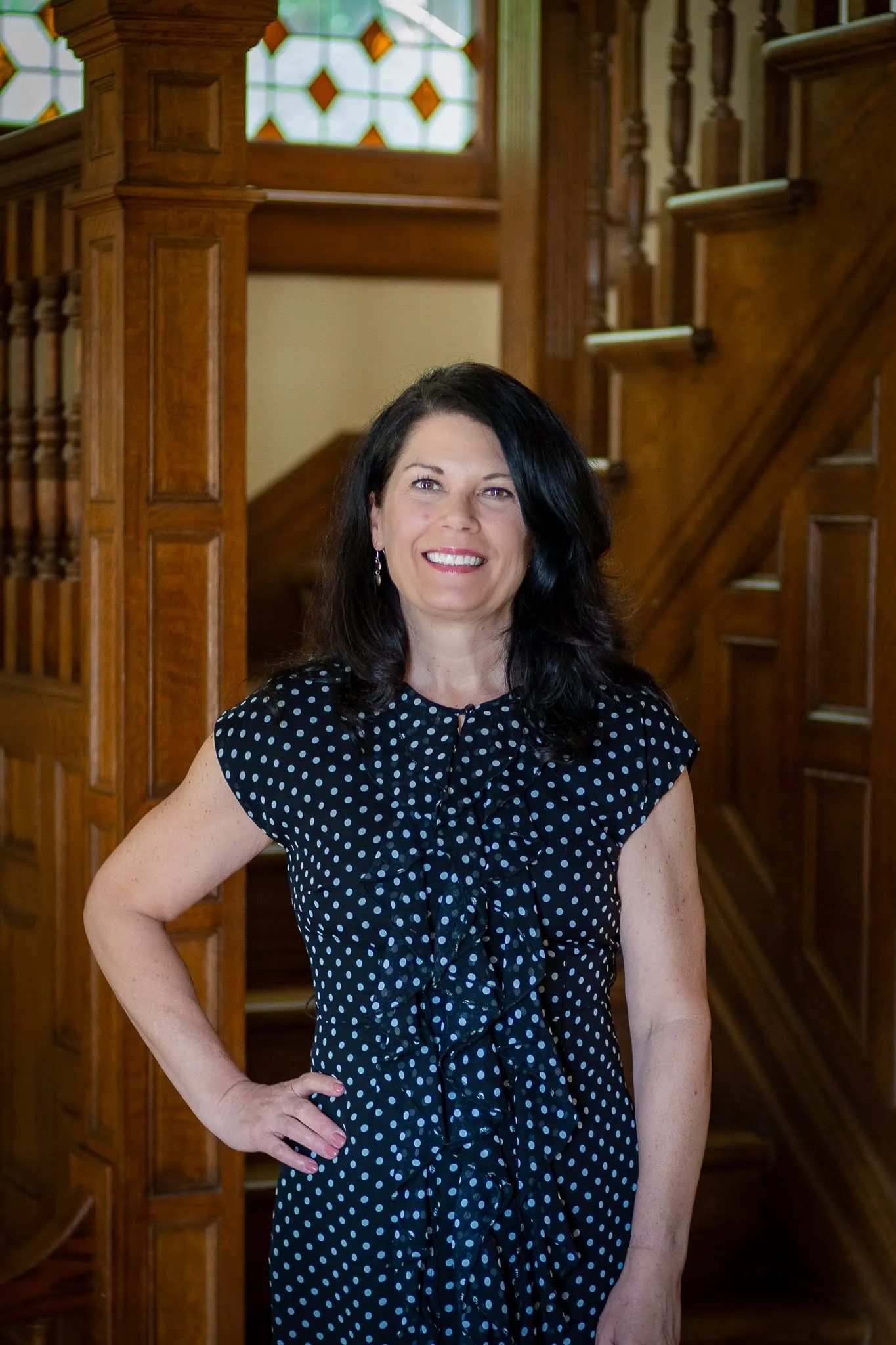 Melissa J. Hessler, partner at Nelson Law Firm, at the stained-glass staircase of the firm's historic Denver office