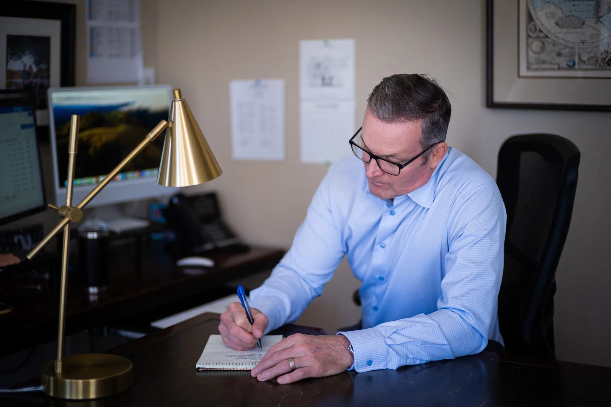 An attorney working at his desk at Nelson Law Firm, photographed by UPWARD